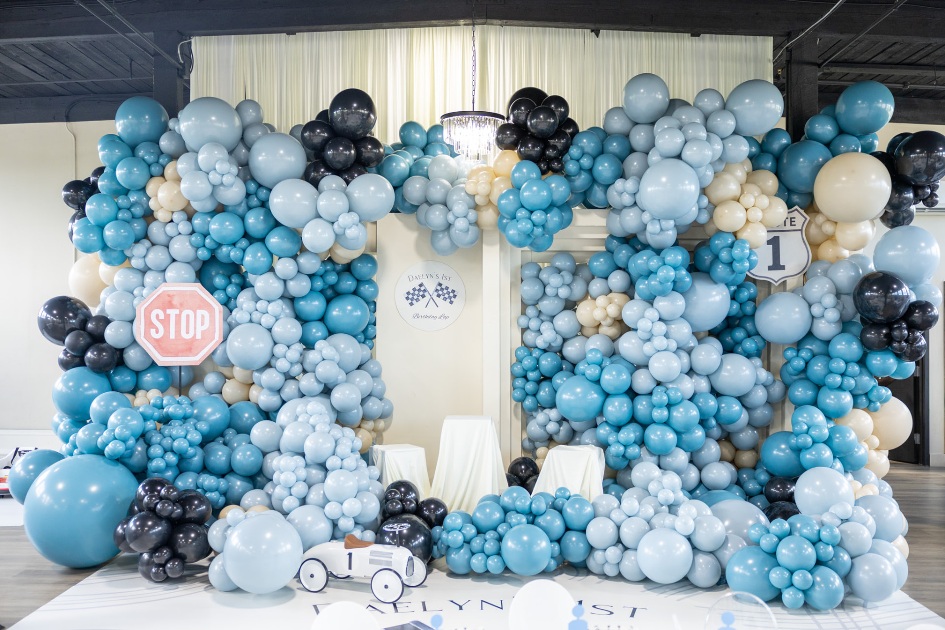 Blue balloon wall installation for a first birthday party