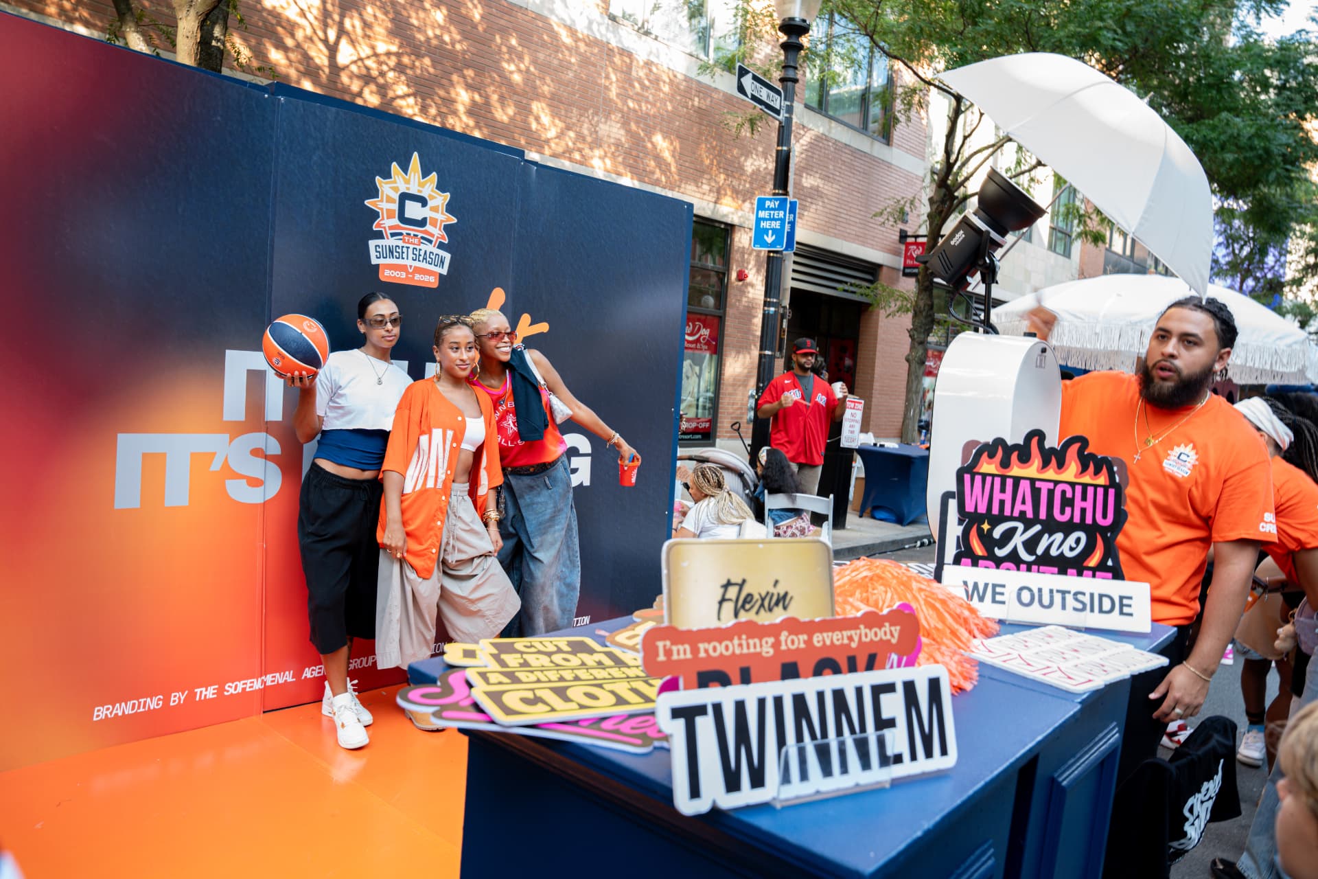 Guests posing at an outdoor branded photo activation